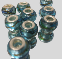 Blue glass beads with silver accents on a light gray background